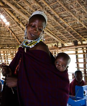 Masai teacher with baby.The Maasai (also Masai) are a Nilotic ethnic group of semi-nomadic people located in Kenya and northern Tanzania. On March, 5th 2009. Tanzania. 