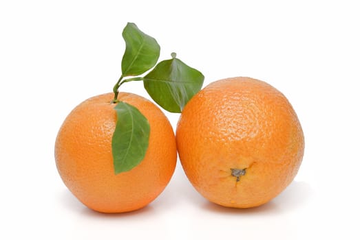 Spanish oranges from Valencia with leaves and its juice isolated on a white background.