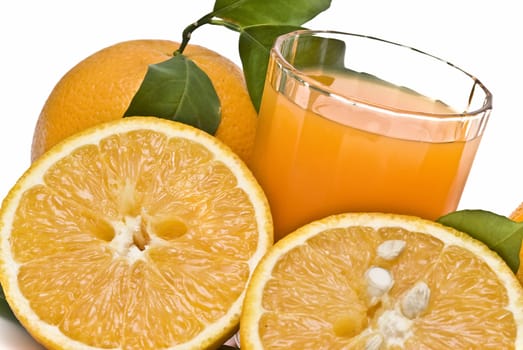 Spanish oranges from Valencia with leaves and its juice isolated on a white background.