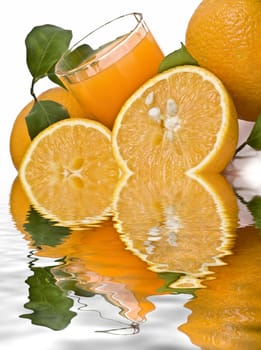 Spanish oranges from Valencia with leaves and its juice isolated on a white background.