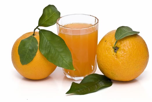 Spanish oranges from Valencia with leaves and its juice isolated on a white background.