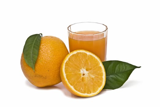 Spanish oranges from Valencia with leaves and its juice isolated on a white background.