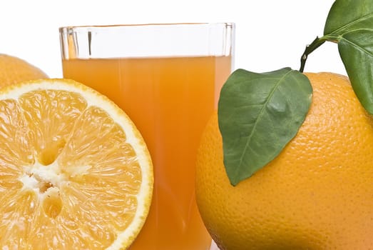 Spanish oranges from Valencia with leaves and its juice isolated on a white background.