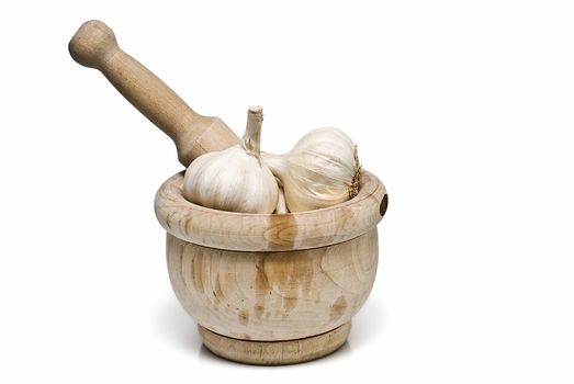 Mortar and pestle with some garlic isolated on a white background.