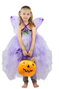Child dressed as a fairy for Halloween and holding a basket of candy.
