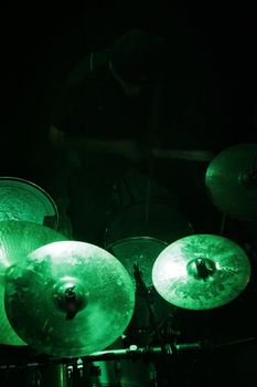 concert, drummer in shadow, green light on drums