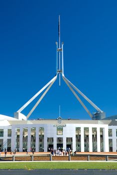 people standing in front of Canberra Parliament House, clear blue sky