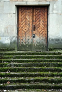 dirty stairs covered with moss, old wooden door,