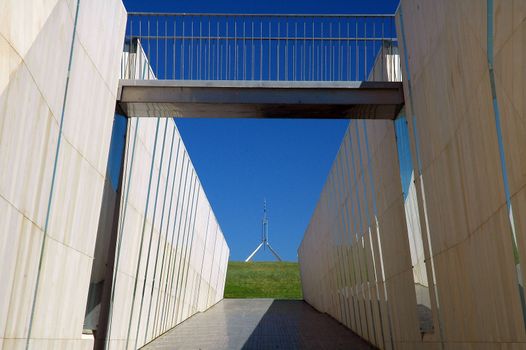 modern construction in Canberra, australian flag on Canberra Parliament House in background