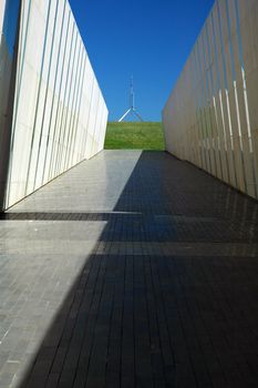 modern construction in Canberra, australian flag on Canberra Parliament House in background