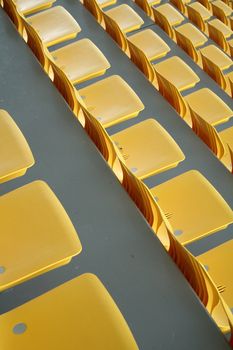 empty yellow stadium seats, grey concrete, part of sport hall