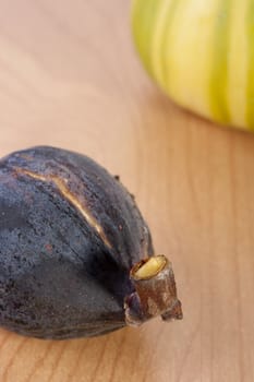 Ripe fruits of a fig on a wooden table.