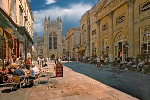 A busy street in Bath city centre, showing the historic abbey.