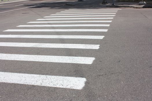 Fresh road markings: a pedestrian crossing with diagonal stripes.(zebra)