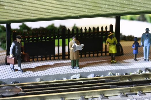 Train station toy set up showing passenger and worker.