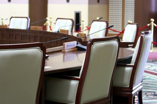 International conference oval  room with tables chairs. 
