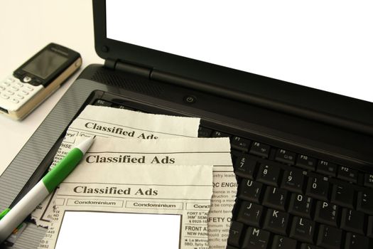 classified  section of the newspaper on a laptop computer
