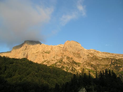 Mountains; rocks; a relief; a landscape; a hill; a panorama; Caucasus; top; a slope; a snow; a cool; clouds