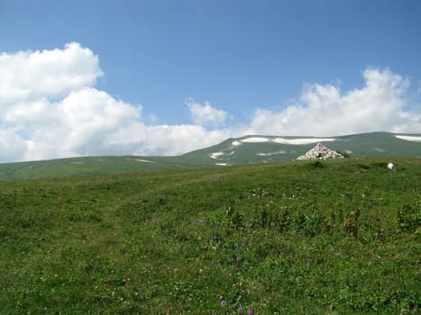 Mountains; rocks; a relief; a landscape; a hill; a panorama; Caucasus; top; a slope; a snow; a cool; clouds