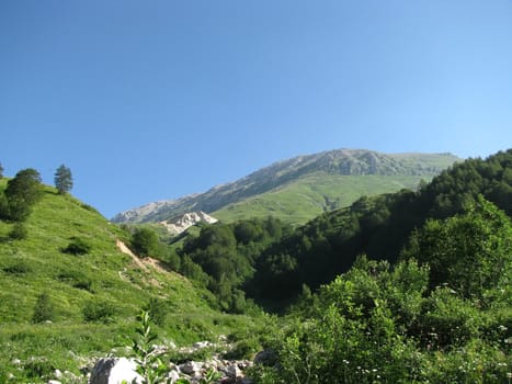 Mountains; rocks; a relief; a landscape; a hill; a panorama; Caucasus; top; a slope; a snow; a cool; clouds