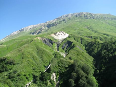 Mountains; rocks; a relief; a landscape; a hill; a panorama; Caucasus; top; a slope; a snow; a cool