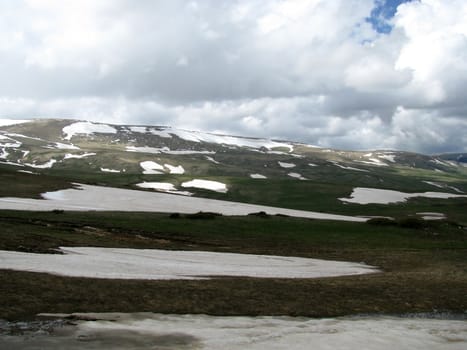 Mountains; rocks; a relief; a landscape; a hill; a panorama; Caucasus; top; a slope; a snow; a cool; clouds