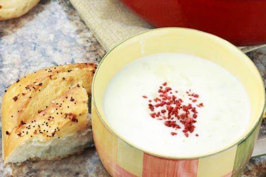 Homemade potato soup garnished with vegetarian bacon bits and served with Italian herb bread.