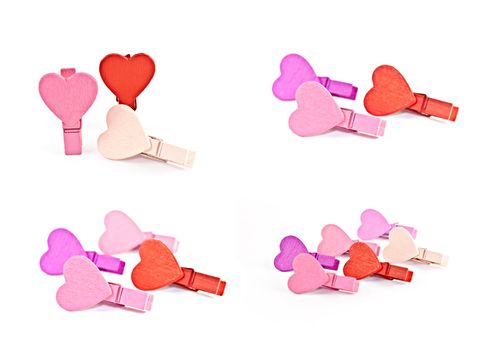 Colorful wooden pegs with a heart on a white background. Macro photography.