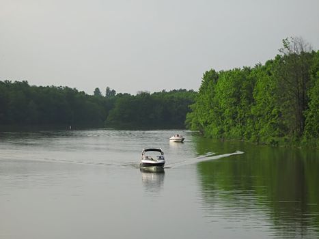 A photograph of motorized boats on a waterway.