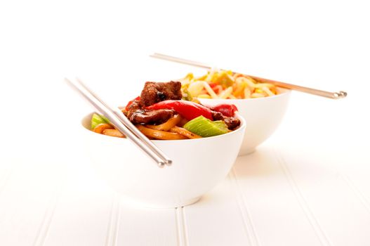 Oriental noodles with black bean beef in a bowl.