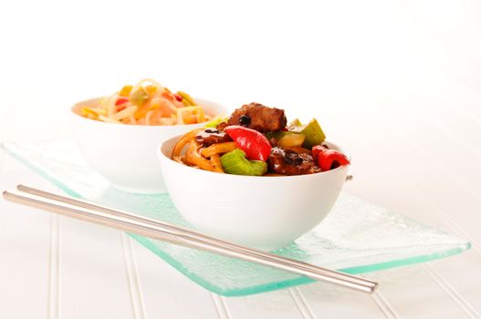 Delicious healthy oriental stirfry in white bowls.