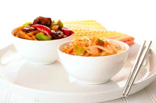 Bowls of delicious chinese food on a white background.