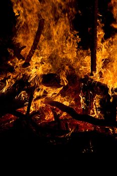 mountiain of debris burning with intensity in the night