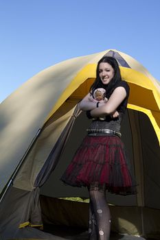 twenty something women wearing goth style clothes and holding a small baby doll