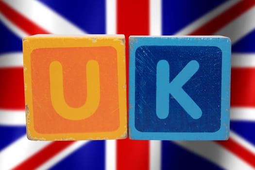 toy letters that spell uk against a flag background with clipping path