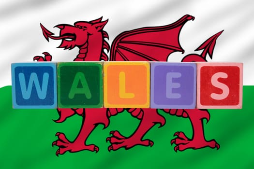 toy letters that spell wales against a flag background with clipping path