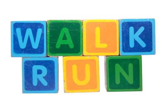 toy letters that spell walk and run against a white background with clipping path