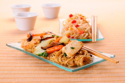 Chow mein noodles topped with chicken and vegetables.