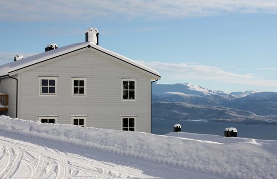 Snowy house in a white winter landscape in western Norway.