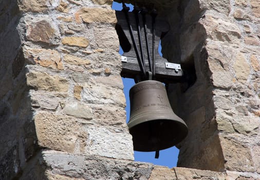 old mediterranean belfry with stone wall texture