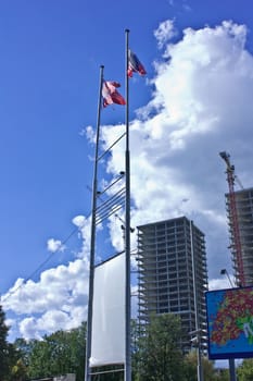 New and waving Russian flags on the background of sky and clouds