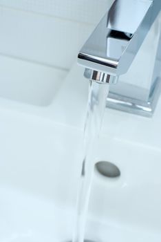 Closeup of modern bathroom tap in blue