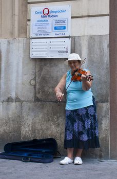 She plays the violin on the streets of the city