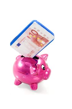 a pink piggybank with chocolate banknote