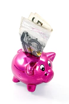 five euro in a  pink piggybank