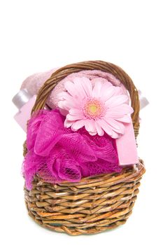 a towel, a sponge, soap and a flower in a basket