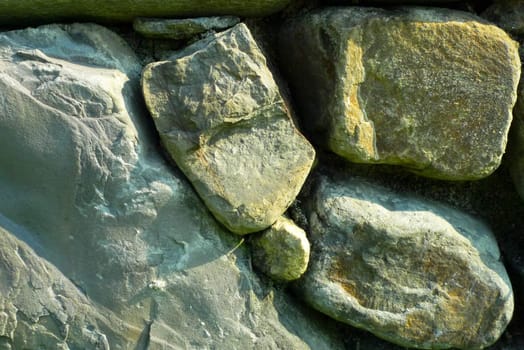 Irregular-shaped stone wall stone wall is a dark background