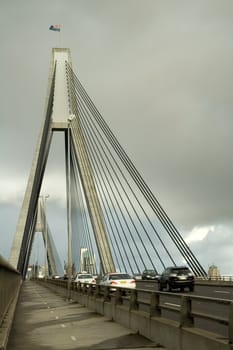 anzac bridge in sydney, cars in motion, cloudy sky