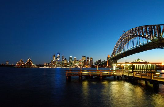 famous sydney landmarks - opera house, harbour bridge, sydney tower, port jackson. color reflections in water