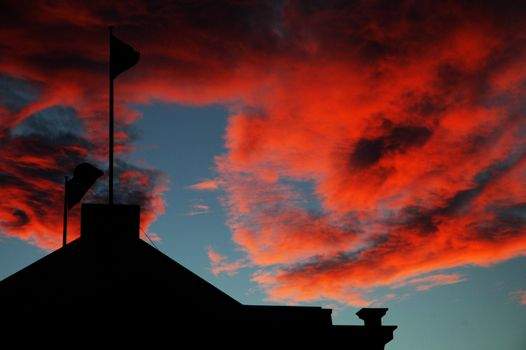 dusk, red clouds, blue sky, building silhouette